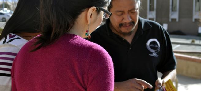 Sonny Weahkee, a health guide working to sign Native Americans up for health insurance, demonstrates his outreach “rap” with coworkers outside the nonprofit’s headquarters in Albuquerque.