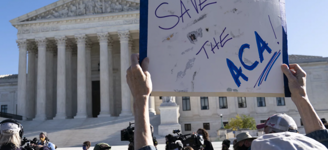 A demonstrator holds a sign in support of the Affordable Care Act in front of the U.S. Supreme Court last November. On Thursday, the justices did just that. | Alex Brandon | AP