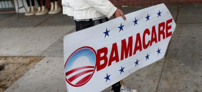 A sign directing people where they can sign up for the Affordable Care Act, also known as Obamacare. Photographer: Joe Raedle/Getty Images